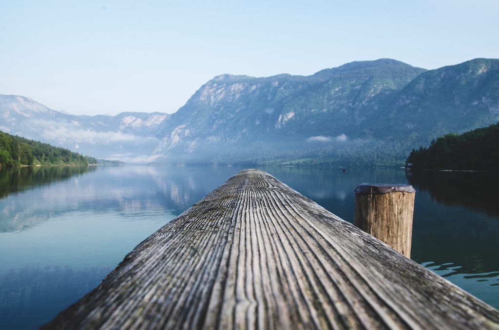 POV shot - over the edge of bridge with a lake view - photo by Krivec Ales from Pexels